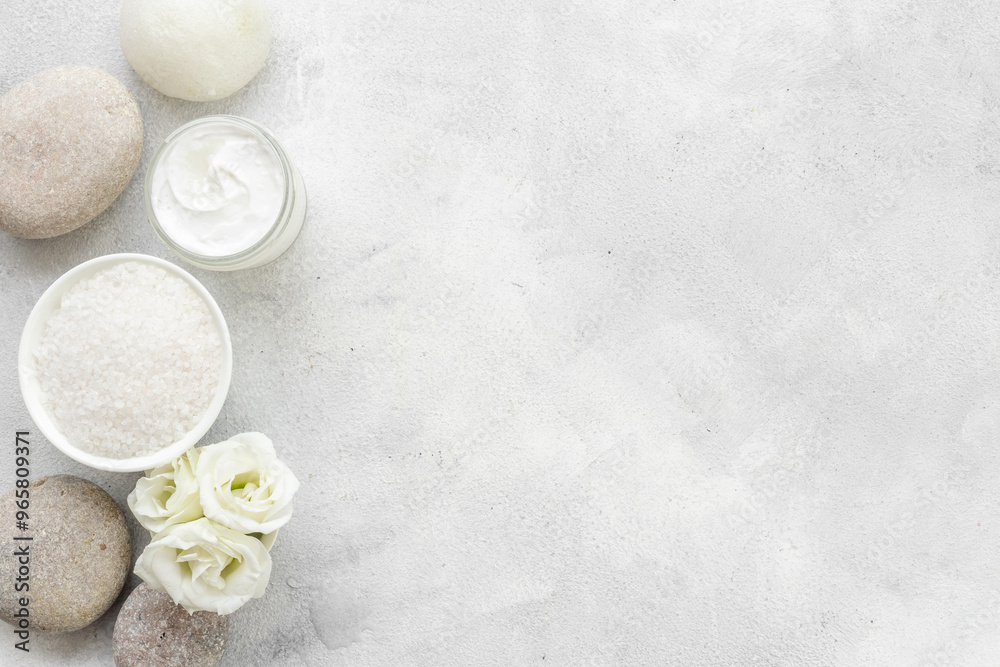 White roses and stones with skin care cosmetics products. Mock up, top view White roses and stones with skin care cosmetics products. Mock up, top view