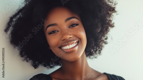 Sophisticated woman smiling against a light gradient background