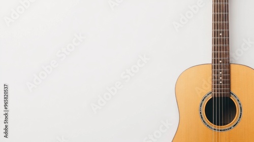 Vintage acoustic guitar, leaning against a clean white backdrop, showcasing rich wood grain details, embodying simplicity and elegance in design.