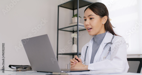 Young asia people female medic live talk speak look at laptop computer work in online visit clinic care to help see patient on digital telehealth telemedicine smart covid teleconsult VoIP service app. photo