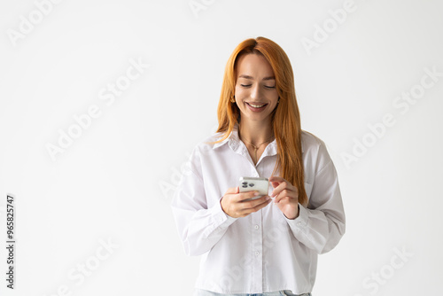 Smiling corporate woman chatting in messanger app on smartphone onwhite background photo