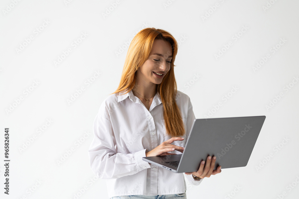 Portrait of a businesswoman working on laptop computer isolated over white background Portrait of a businesswoman working on laptop computer isolated over white background