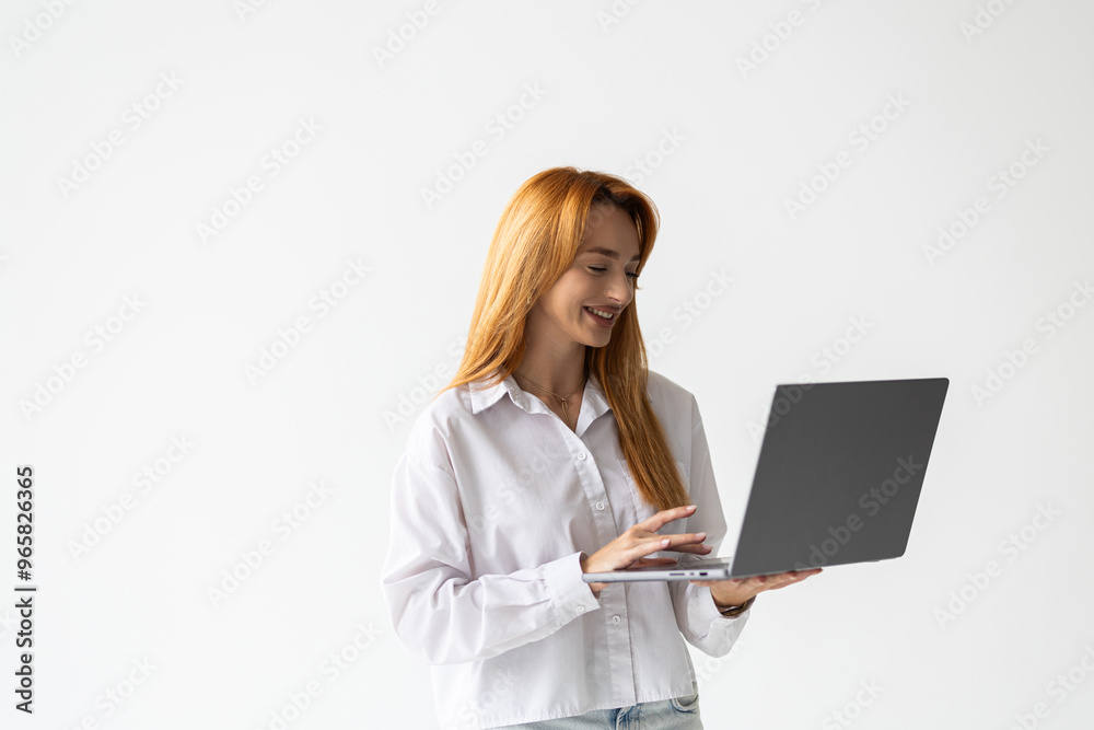 Portrait of young woman answer clients on laptopstanding over white background Portrait of young woman answer clients on laptopstanding over white background