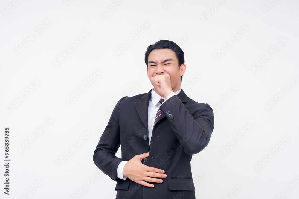 A young cheerful asian business executive in a suit and tie chuckling, trying to cover his laughter with his hand. Isolated on a white background. A young cheerful asian business executive in a suit and tie chuckling, trying to cover his laughter with his hand. Isolated on a white background.