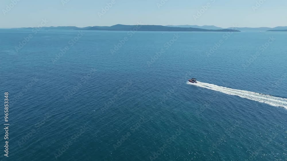 Small speedboat gliding through waves of Adriatic sea near Kornati archipelago, Croatia. Travel, tourism, vacation, free lifestyle and luxury concepts. Aerial chase drone shot. 4K 60FPS Small speedboat gliding through waves of Adriatic sea near Kornati archipelago, Croatia. Travel, tourism, vacation, free lifestyle and luxury concepts. Aerial chase drone shot. 4K 60FPS