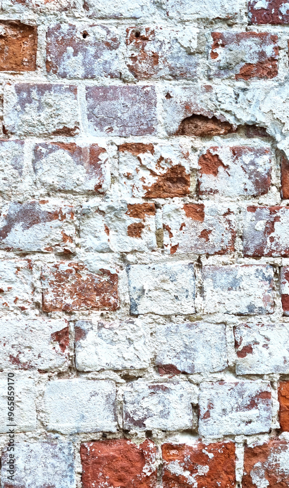Ancient ruined brick wall with paint residue. Brick weathering. Selective focus Ancient ruined brick wall with paint residue. Brick weathering. Selective focus