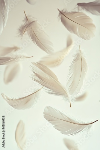 Floating white feathers on soft beige background photo