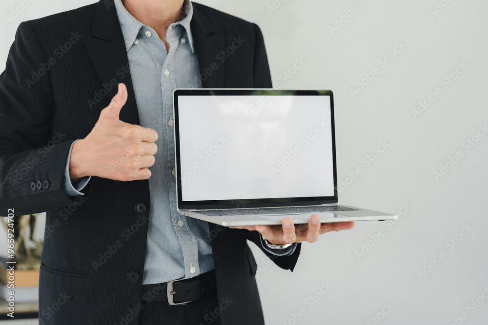 Professional man in suit showing laptop with blank screen Professional man in suit showing laptop with blank screen