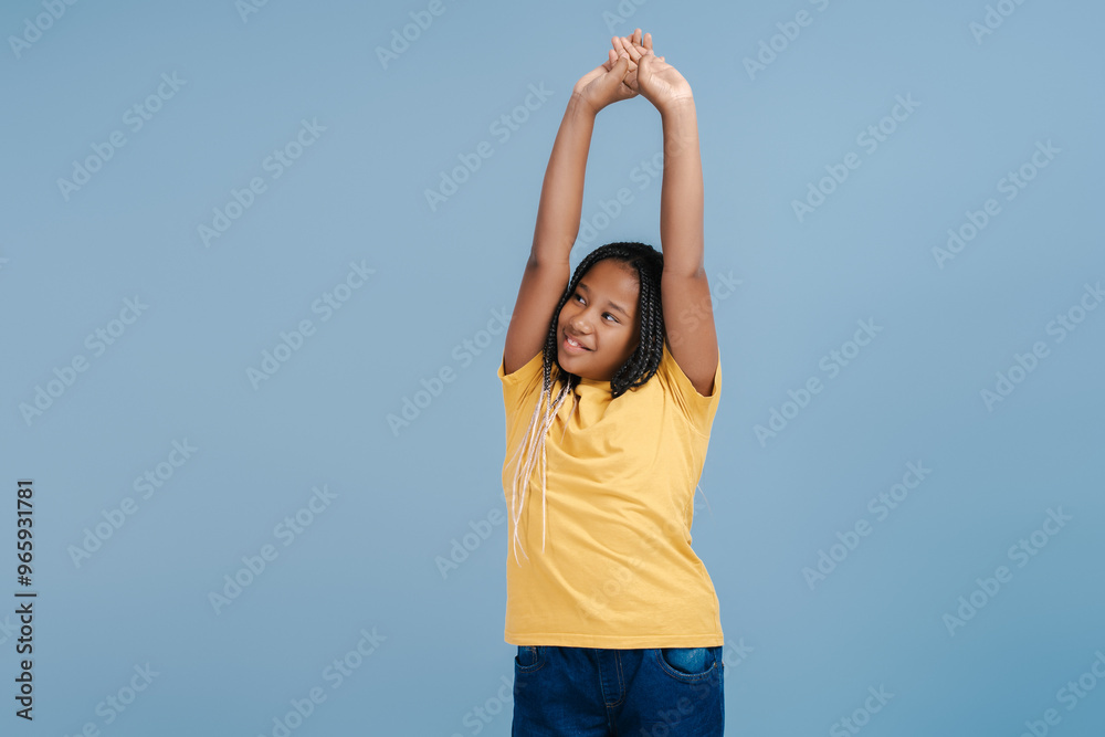 Smiling African girl with hands up, having fun, celebration, dancing Smiling African girl with hands up, having fun, celebration, dancing