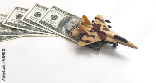 Background of one hundred dollar bills with model fighter airplane 