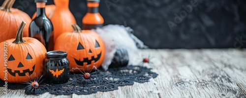 Festive Halloween decor featuring carved pumpkins, black bottles, and lace on a rustic wooden surface. photo