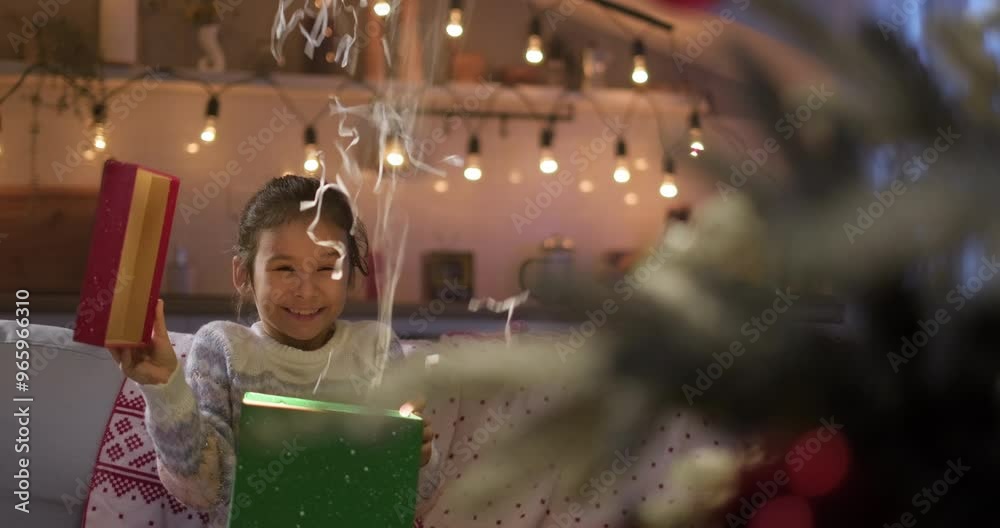 Little girl opens Christmas gift box with confetti explosion. Excited happy kid, Christmas magic and surprise. Holidays and celebrations concept Little girl opens Christmas gift box with confetti explosion. Excited happy kid, Christmas magic and surprise. Holidays and celebrations concept