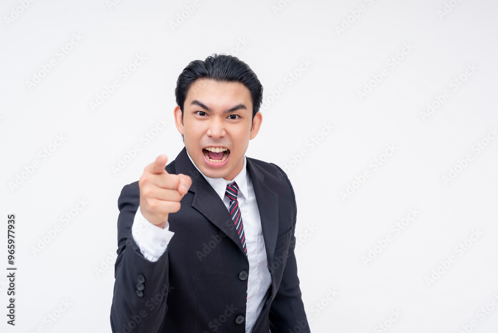 A young and irate asian business executive screaming you're fired, pointing with his finger. Isolated on a white background. A young and irate asian business executive screaming you're fired, pointing with his finger. Isolated on a white background.
