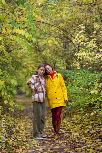 Mother and daughter in the forest in autumn