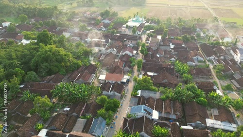 Aerial view of a beautiful small village pointing to the sun in Indonesia. morning sunshine in a small village with spreading trees