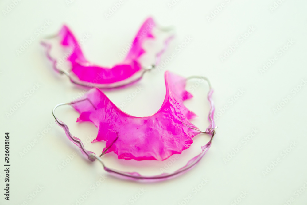 Pink acrylic dental retainer on white background Pink acrylic dental retainer on white background