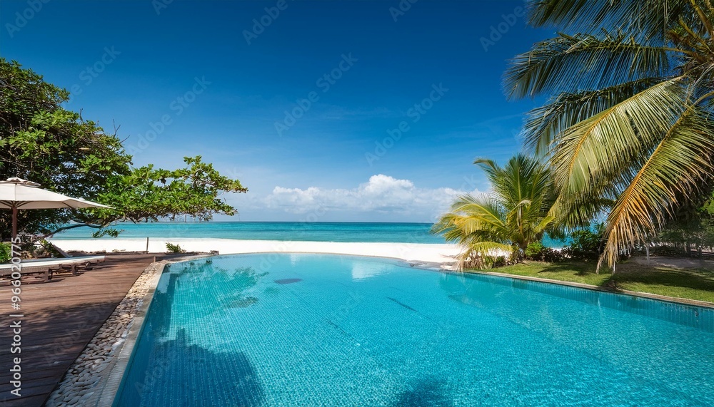 Tranquil poolside scene overlooking a pristine tropical beach with crystal-clear turquoise water Tranquil poolside scene overlooking a pristine tropical beach with crystal-clear turquoise water