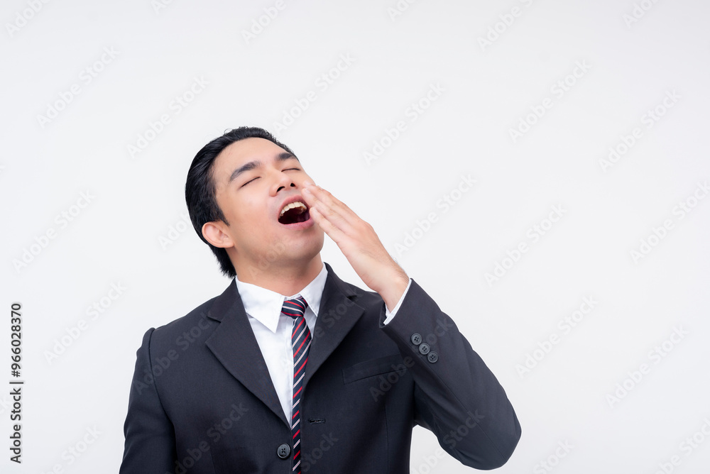 A young asian business executive smiling while yawning. Mocking someone as a boring person. Isolated on a white background. A young asian business executive smiling while yawning. Mocking someone as a boring person. Isolated on a white background.