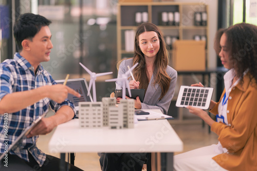 A team of industrial engineers meeting on renewable energy working on innovative solar panel batteries that are efficient in construction projects.