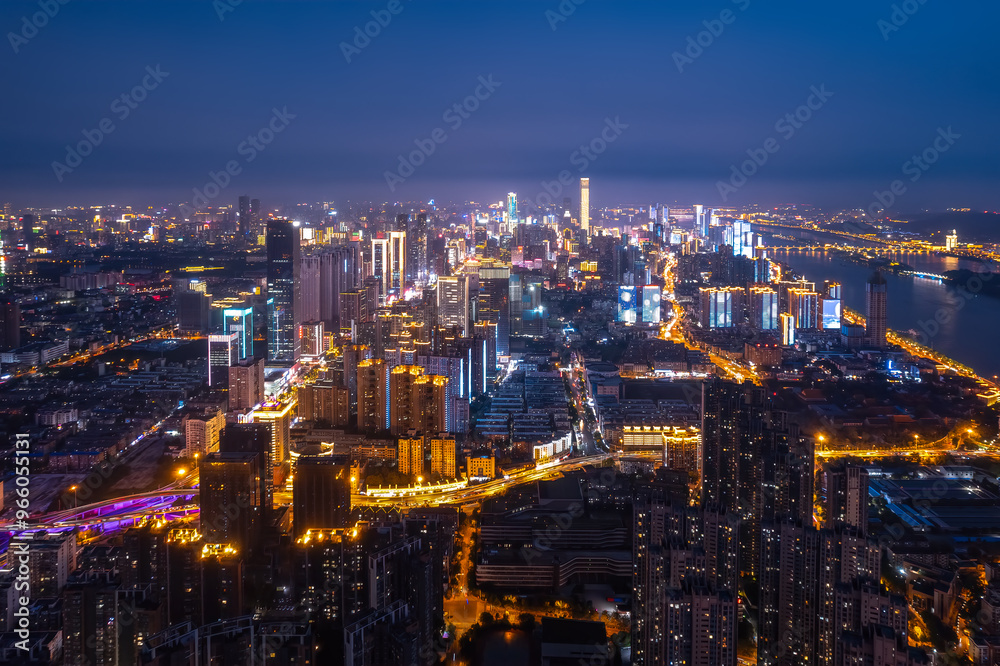 Fototapeta premium Stunning Nighttime Cityscape: Illuminated Skyline with River View