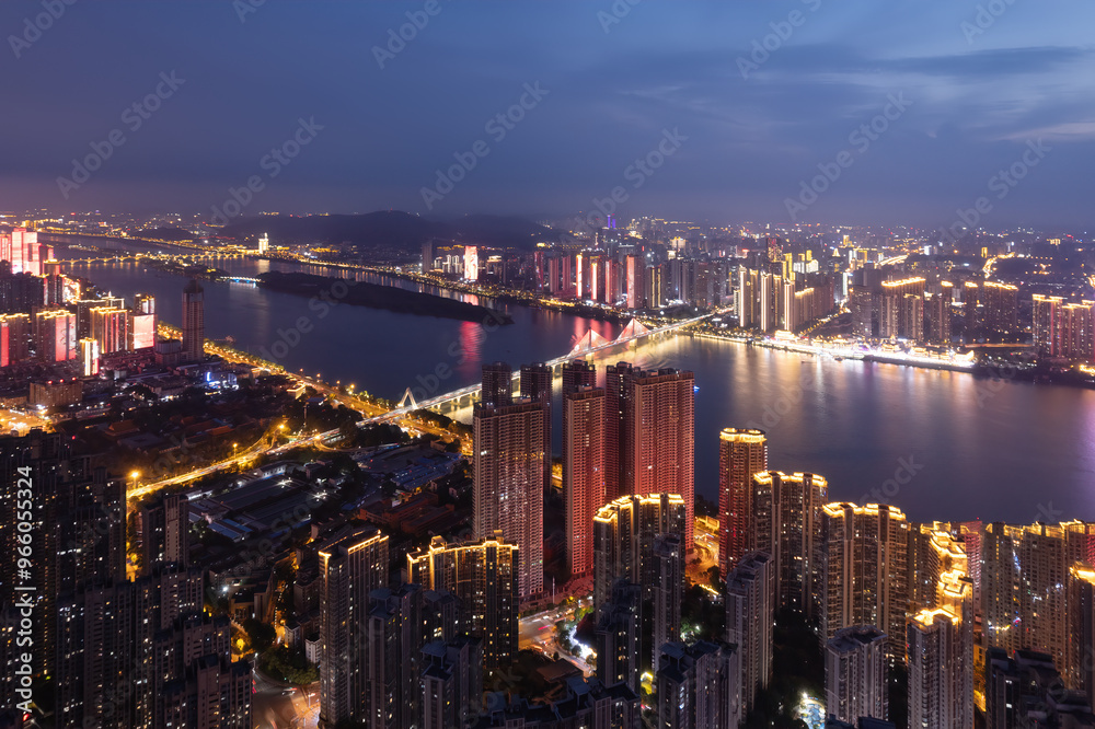 Fototapeta premium Stunning Night Skyline Overlooking a Vibrant City River