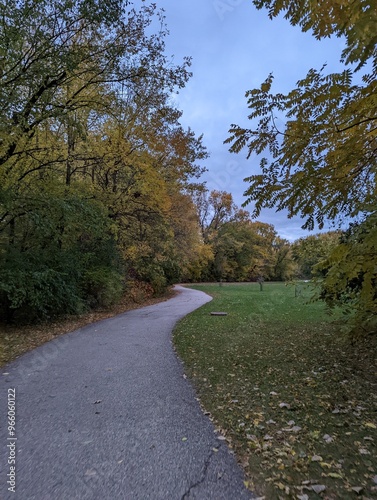 Trees start to change in the cooler weather of fall along the multi-use path in Willow Creek Park, Iowa City, IA.