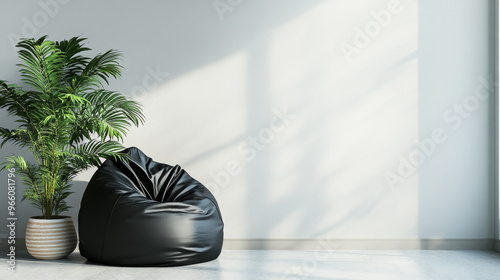 A black bean bag chair sits next to a houseplant in a room with light gray walls. There's room for writing something here.