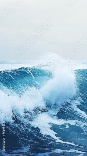 Large wave crashing with white foam in the blue ocean. photo