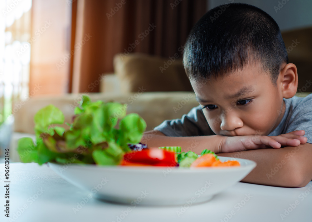 Little cute boy refuses to eat healthy vegetables, Children do not like to eat vegetables, Nutrition healthy eating habits for kids concept, Children do not like to eat vegetables. Little cute boy refuses to eat healthy vegetables, Children do not like to eat vegetables, Nutrition healthy eating habits for kids concept, Children do not like to eat vegetables.