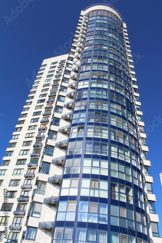 modern office building, the facade of the new building against the blue sky