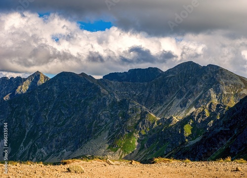 Rocky mountain ridge. Tourist view during autumn hiking with dramatic sky. Western Tatras, Rohace, Slovakia.