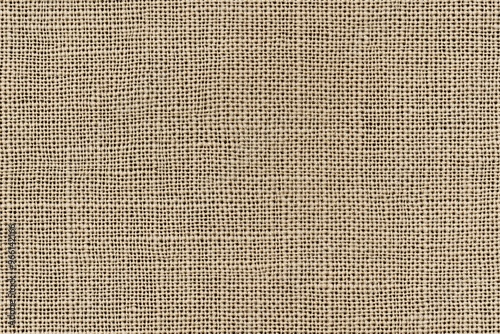 Textured beige cotton canvas fabric, showcasing a natural woven pattern. The fabric appears soft and slightly coarse, ideal for various textile applications.