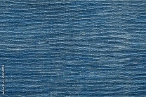 Textured blue cotton chambray fabric, showcasing a woven pattern with subtle variations in color and depth.