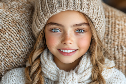 Smiling girl with winter fashion, wearing a cozy knit hat and scarf, enjoying the cold season photo