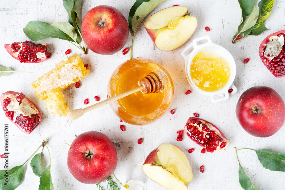 rosh hashana holiday - honey with apple and pomergranate over white desk background rosh hashana holiday - honey with apple and pomergranate over white desk background