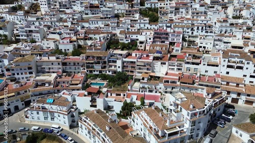 Panoramic view of typical andalusian white village Mijas located on the Costa del Sol, Spain. Residential area with a lot of white washed houses, terracotta roofs, narrow streets. 
