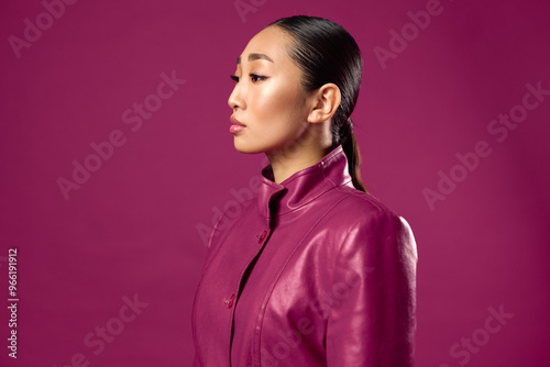 Asian woman wearing purple leather jacket looking to the side on purple background trendy and stylish asian beauty photo