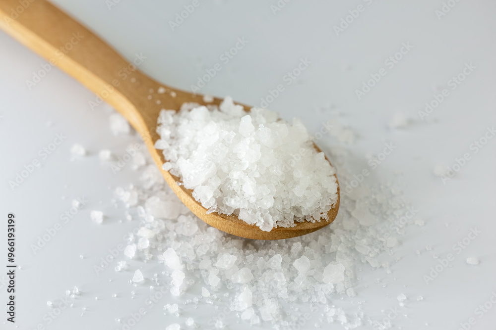 Organic rock salt in wooden spoon on white background. Transparent, healthy rock salt extracted in Turkey. Organic rock salt in wooden spoon on white background. Transparent, healthy rock salt extracted in Turkey.