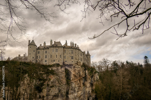 landscape photograph of the castle of Walzin situated on the heights of a hill romantic castle presenting a beautiful facade under a gray autumn sky photo