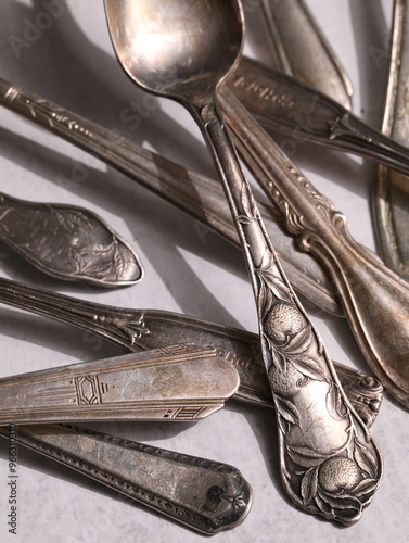 A pile of tarnished silver spoons.