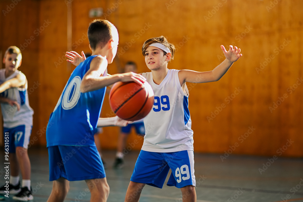 Fototapeta premium Child facing opponent in basketball dribble drill