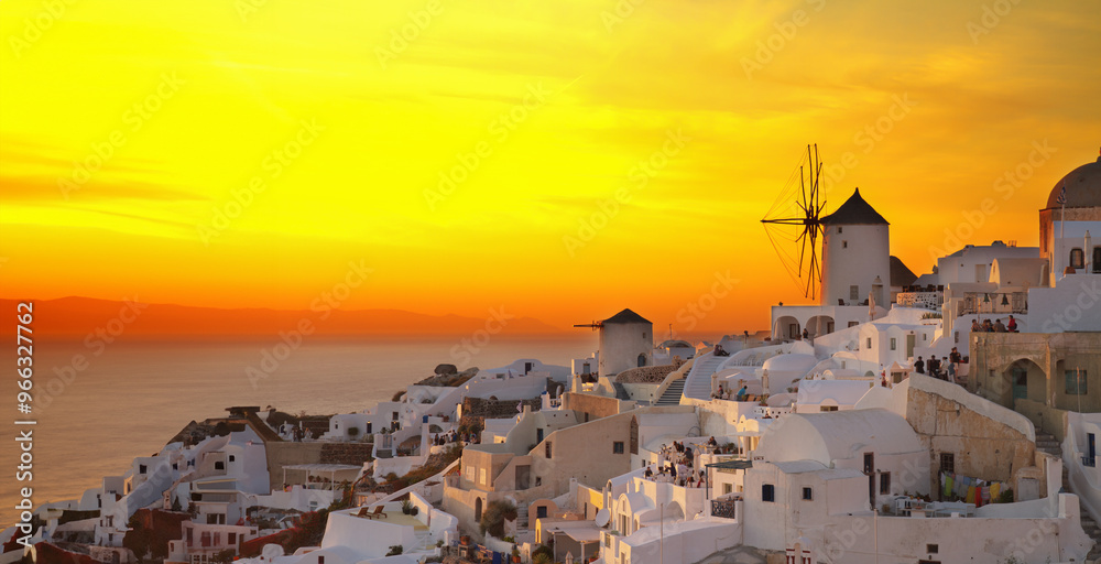 Obraz premium famouse sunset of Oia with windmill, Santorini. HDR