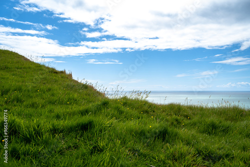 Grassy hill overlooking the sea. Photo taken at Bridport in Dorset, England