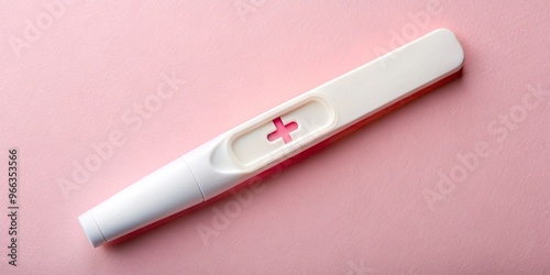 A delicate, white pregnancy test stick with a faint yet unmistakable pink plus sign indication of a positive result, symbols of new life and hope.
