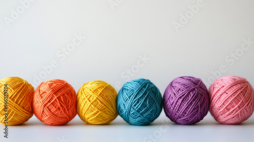 Colorful balls of yarn against a white backdrop.