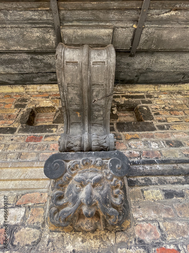 Brugge, Flanders, Belgium - June 25, 2024: Halletoren and Belfry, closeup, Piece of art, stud, in stone supporting roof at inner courtyard photo