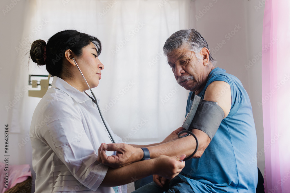Obraz premium Young nurse performing a health check-up on an elderly patient in a doctor's office.