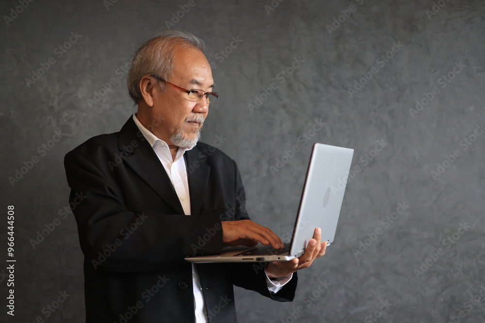 Efficient smart senior businessman Portrait of Smiling Senior Manager Businessman using digital tablet and laptop Efficient smart senior businessman Portrait of Smiling Senior Manager Businessman using digital tablet and laptop