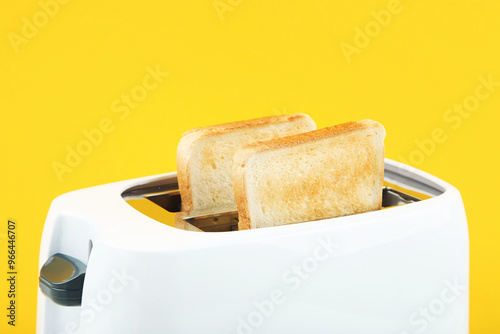 Obraz na płótnie Modern toaster with toast bread on yellow background w salonie
