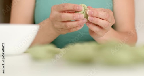 The chef uses his hands to shape food from vegan doug A detailed closeup view of hands skillfully preparing fresh and vibrant ingredients in bustling kitchen setting h. photo